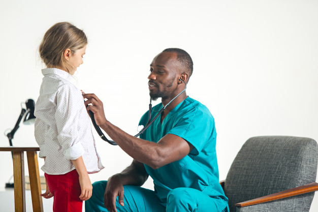Nesta imagem uma criança está em consulta com seu médico pediatra